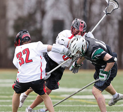 A group of men playing lacrosse. Description generated by AI