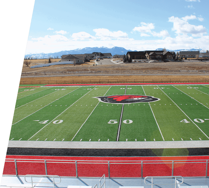 A football field with a red and black striped border. AI generated content