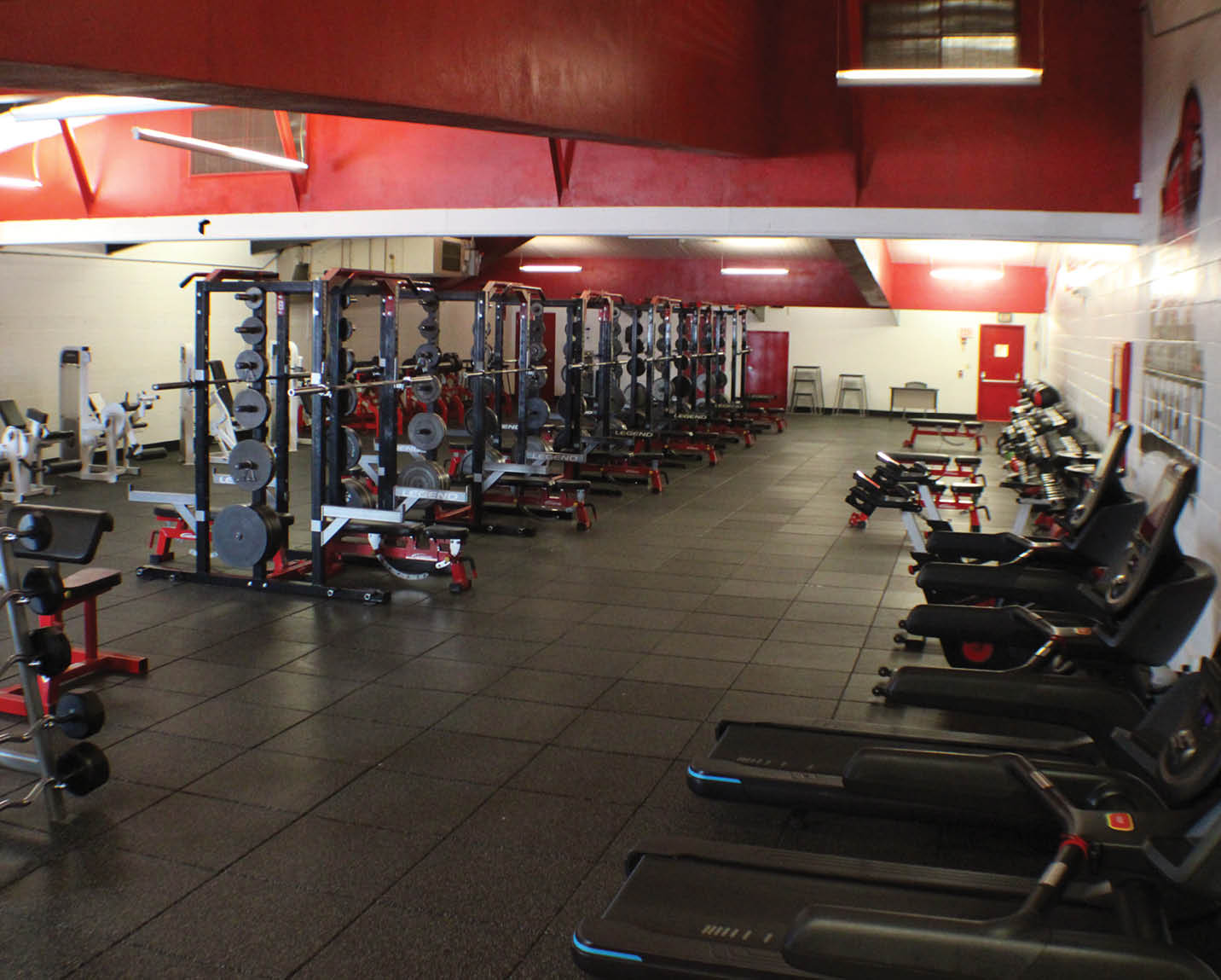 A gym with a red ceiling and black flooring. AI generated content