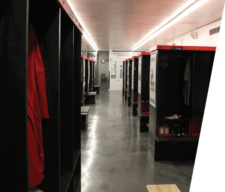 A locker room with a row of lockers and a bench. AI generated content