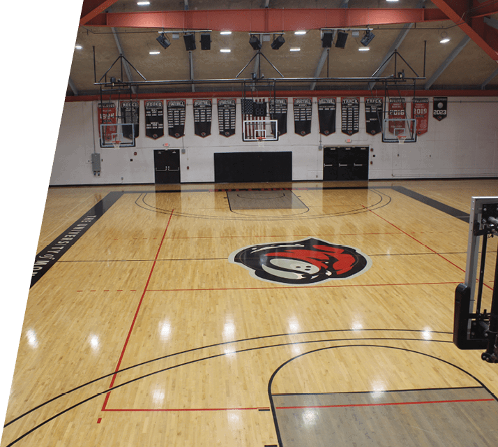 A basketball court with a scoreboard and bleachers. AI generated content