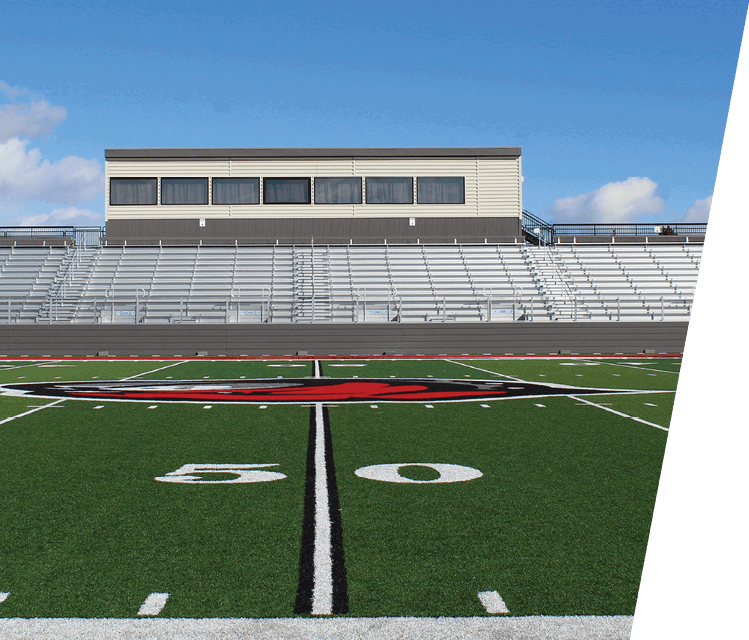 A football field with a black and white striped field marker. AI generated content