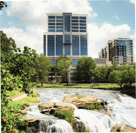 A large waterfall with a city in the background. AI generated content