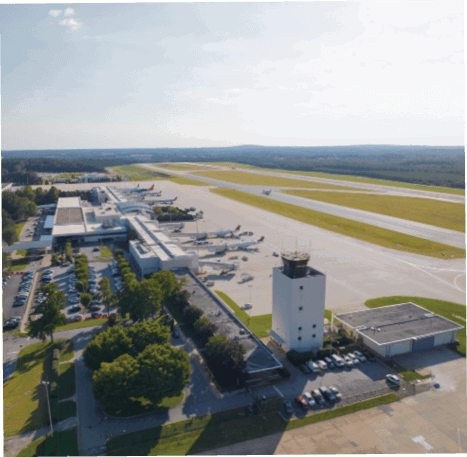 A large airport with multiple airplanes parked on the tarmac. AI generated content