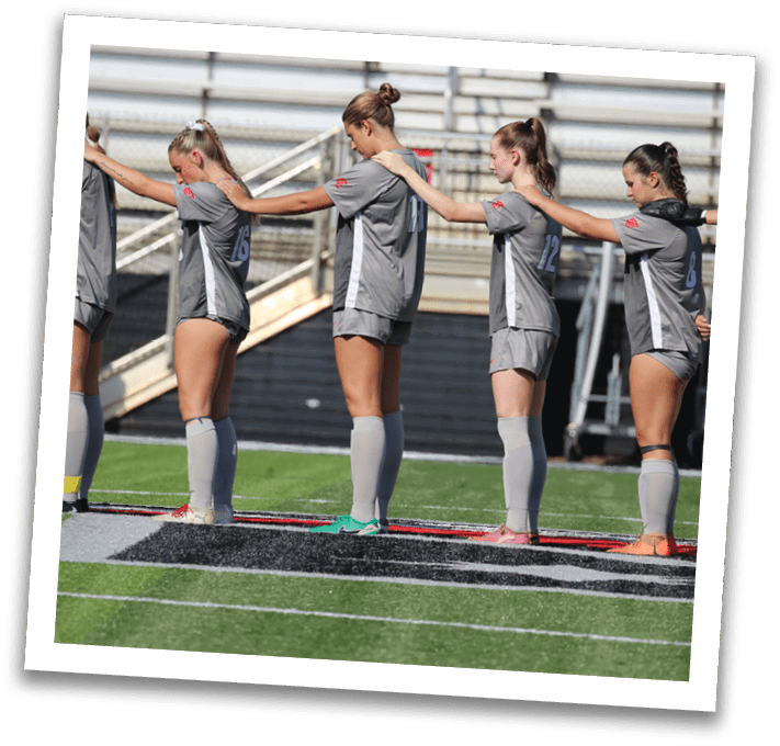 A group of female soccer players are lined up on the field, wearing uniforms and socks. AI generated content