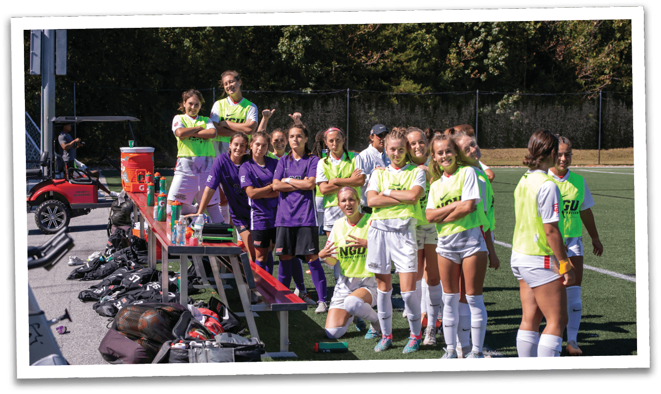 A group of female soccer players are standing on a field, posing for a picture. AI generated content