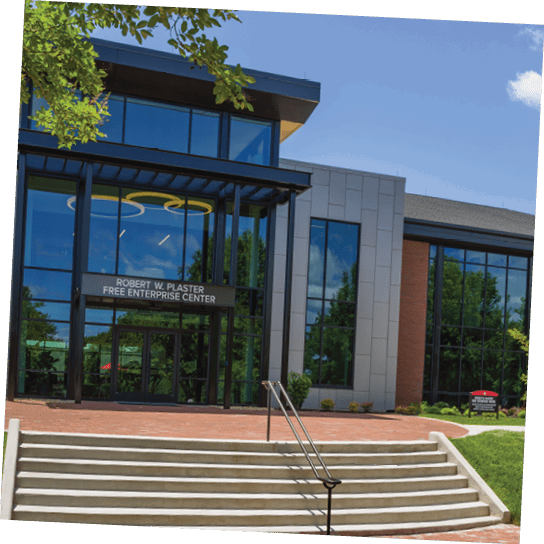 A large building with a glass front and a brick walkway. AI generated content