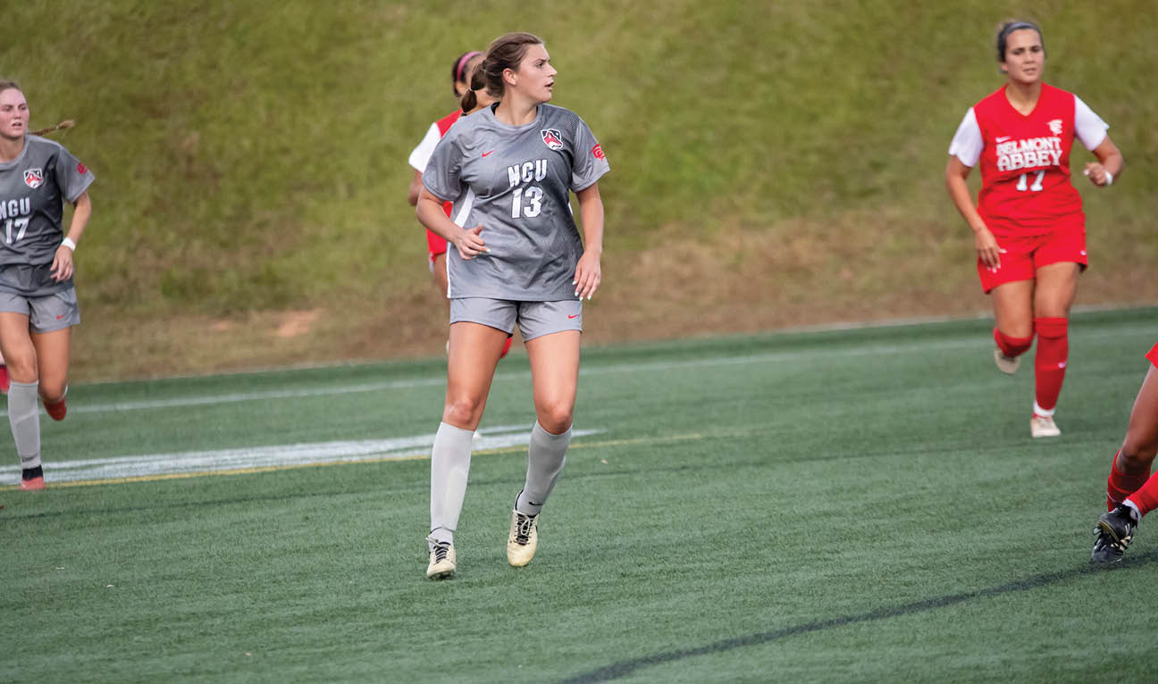 A group of female soccer players running on a field. AI generated content