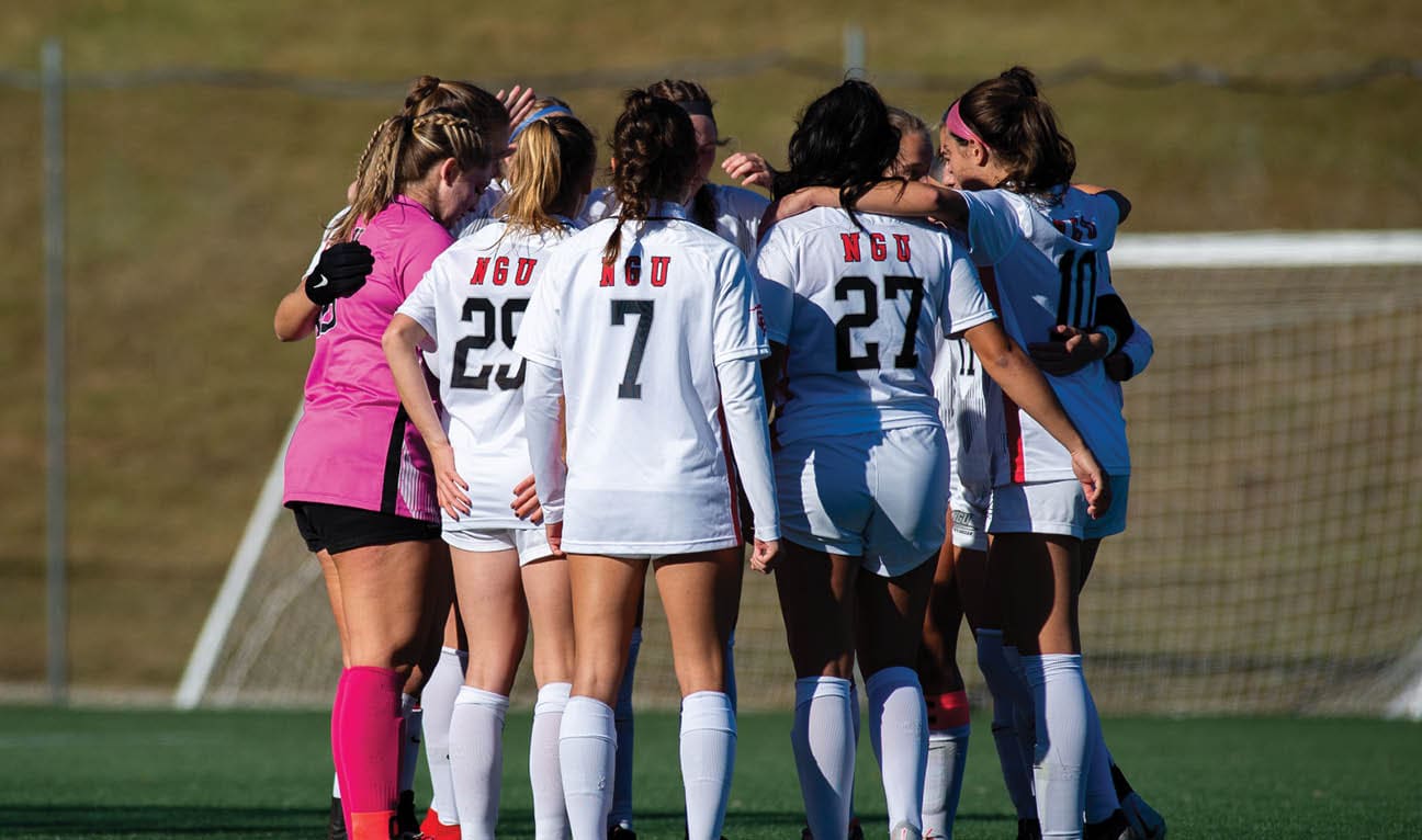 A group of female soccer players huddle together on the field. AI generated content