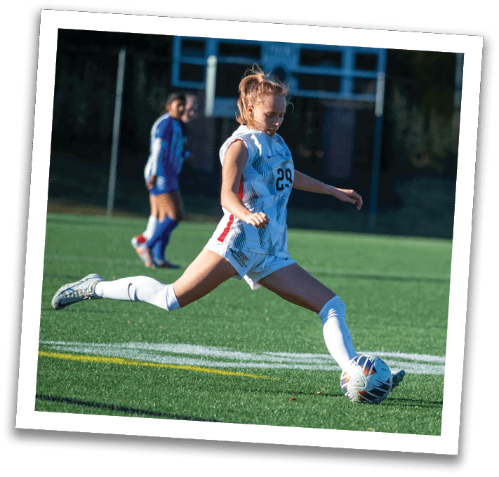A soccer player in a white uniform is kicking a soccer ball on a field. AI generated content