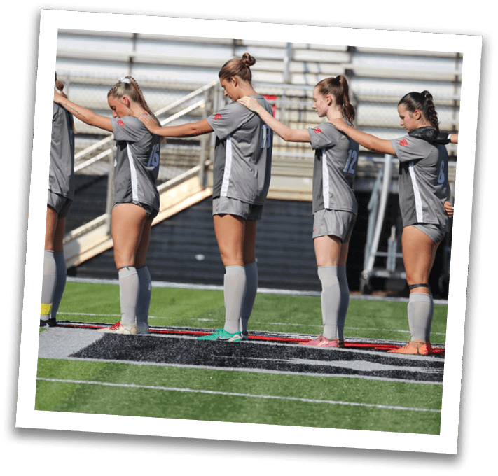 A group of female soccer players are lined up on the field, wearing uniforms and socks. AI generated content