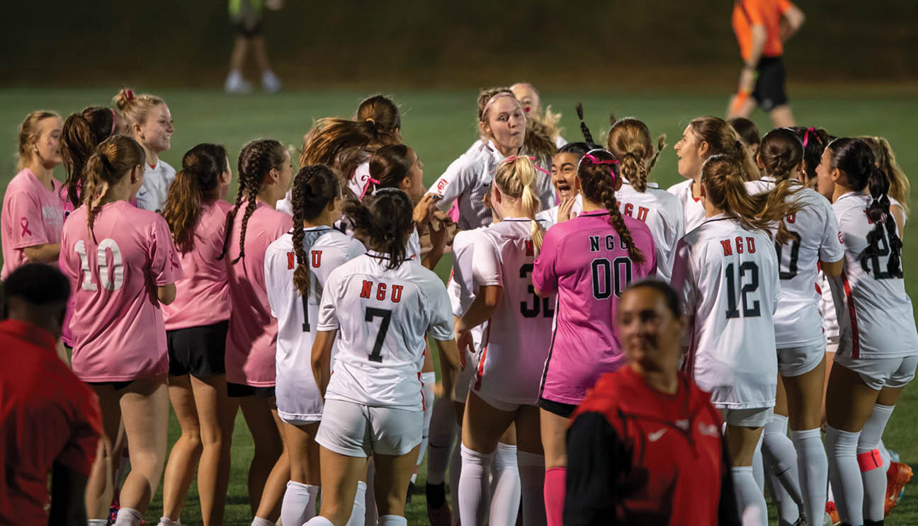 A group of female soccer players huddle together on the field. AI generated content