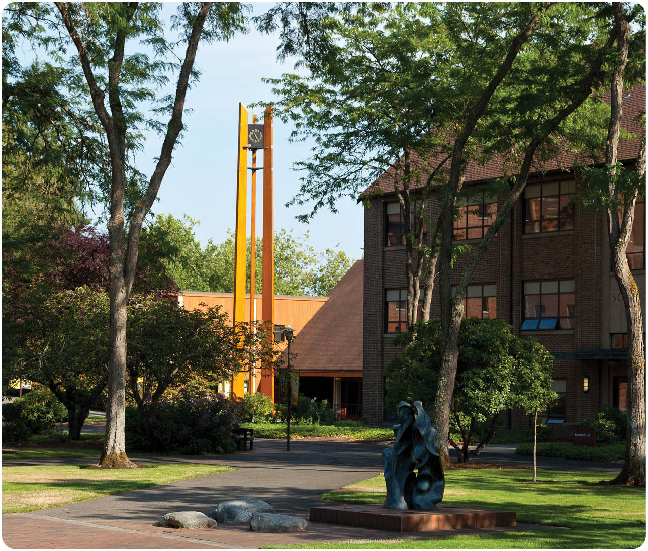 View through the entry of Karen Hille Phillips Center looking toward the Anderson Clock Tower in the late afternoon sunshine at PLU on Thursday, Aug. 13, 2015. (Photo: John Froschauer/PLU)