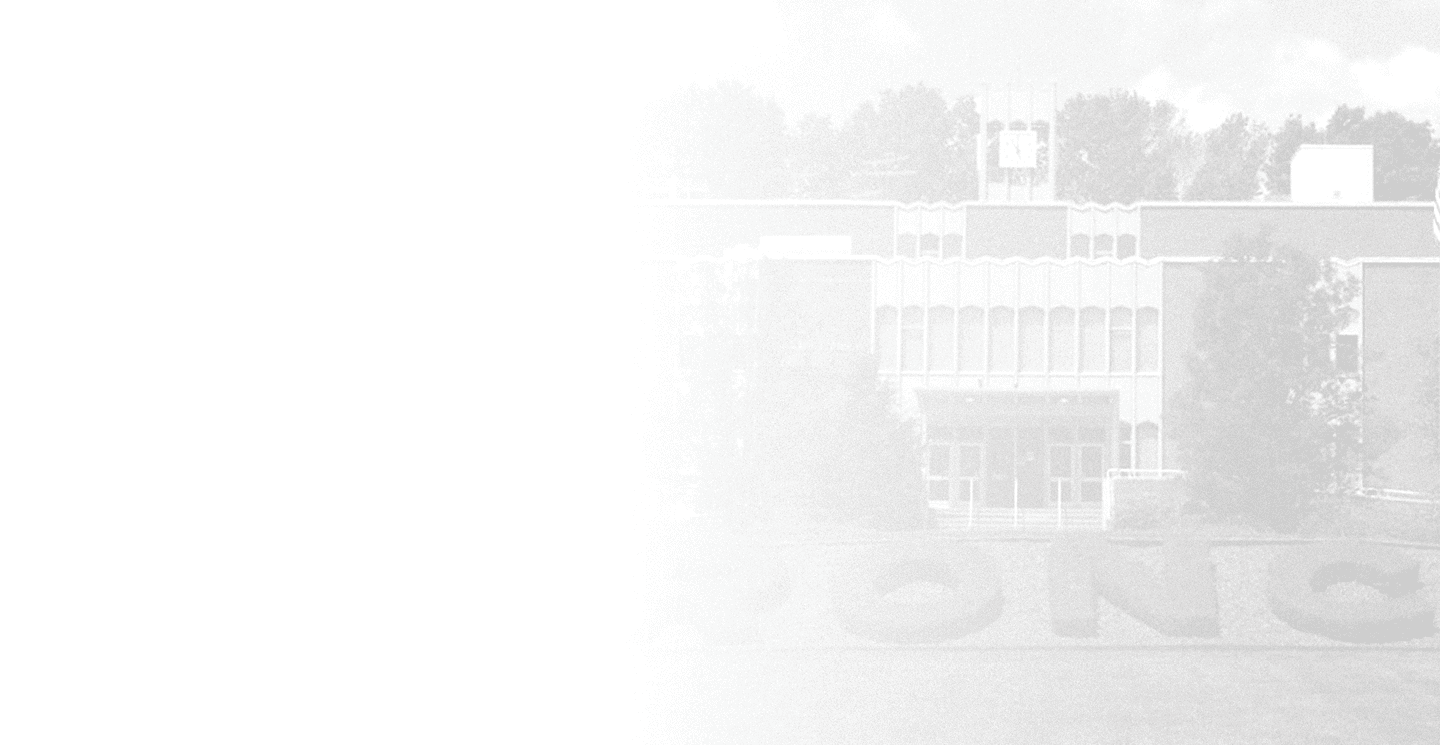 A faded grayscale image shows a large building with trees in front and a clock tower on top. Description generated by AI
